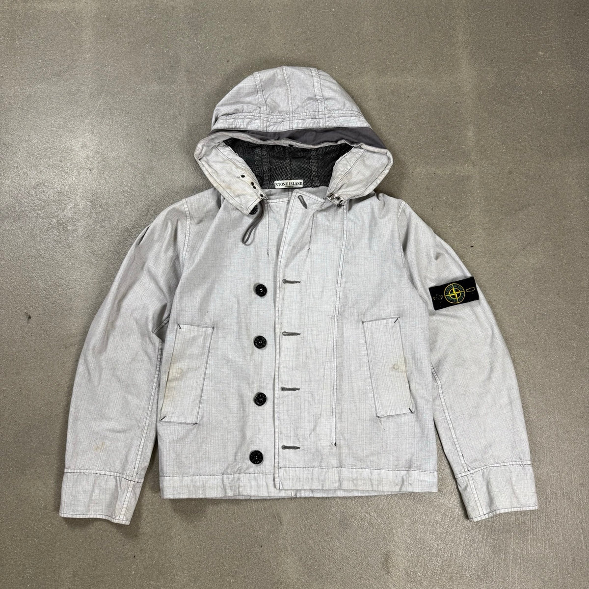 Giacca Stone Island grigia spalmata in cotone e poliuretano con ganci metallici collezione primavera estate 2007 taglia M