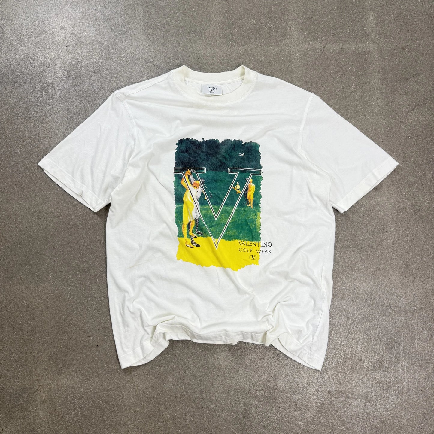T-shirt vintage Valentino Sport Golf Wear anni 80 90 prodotta da Ellesse bianca panna con grafica illustrata taglia XL